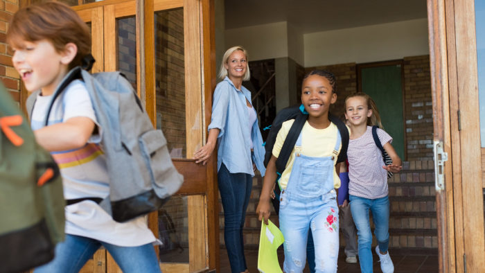 Group,Of,Elementary,School,Children,Running,Outside,At,The,End